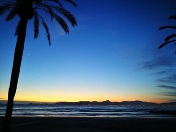 Scenic view of sea against clear sky at sunset