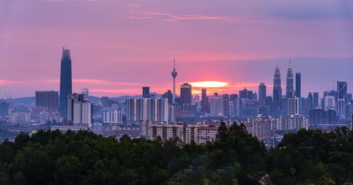 View of buildings in city at sunset