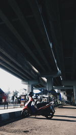 Man on car against sky in city