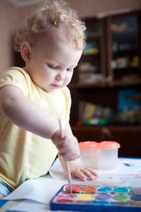 Cute baby girl sitting on table