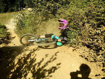 Shadow of woman riding bicycle on sand