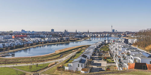 High angle view of river amidst buildings against sky