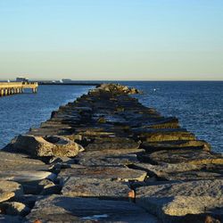 Scenic view of sea with rocks in background