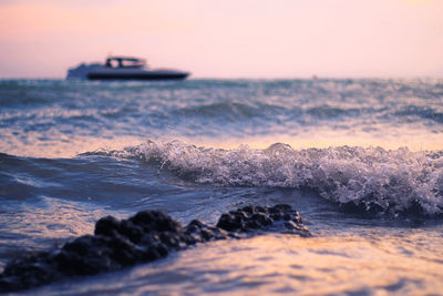 Ship in calm sea against clear sky