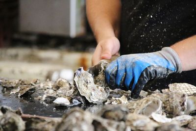 Midsection of man working in a oyster farm