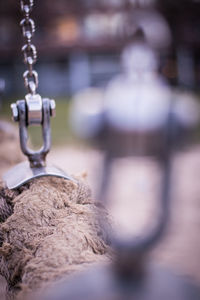 Close-up of ropes tied on chain