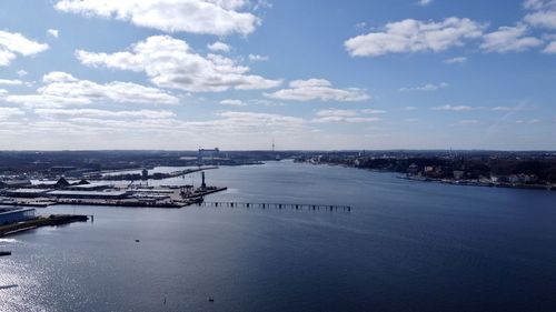 High angle view of sea and city against sky