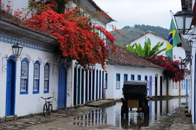 View of building and houses against sky