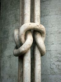 Close-up of chain against wall