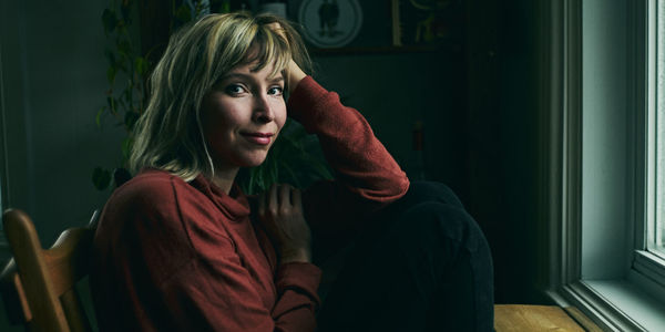 Portrait of beautiful young woman sitting at home