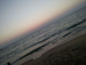 Scenic view of beach against sky during sunset