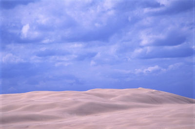 Scenic view of landscape against cloudy sky