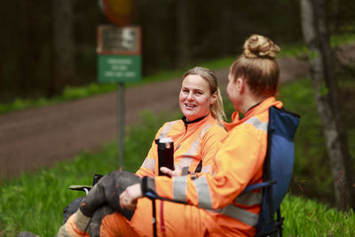 Female lumberjacks resting in forest