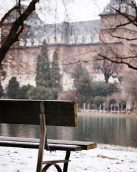 Bench by lake during winter