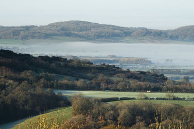 Scenic view of landscape and lake against sky