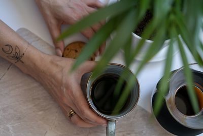 High angle view of woman holding drink