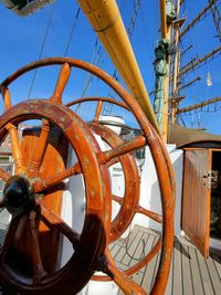 Close-up of rusty wheel against clear sky