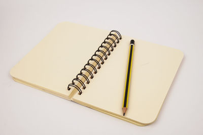 High angle view of pen on book against white background