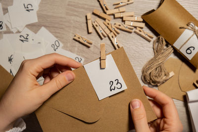 Cropped hands of woman holding paper