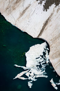 Aerial view of glacier by sea