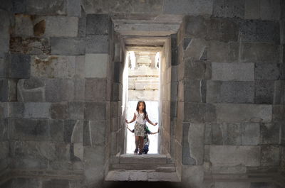 Full length of girls standing against historical building