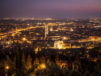 High angle view of city lit up at night