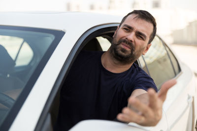 Close-up portrait of man in car