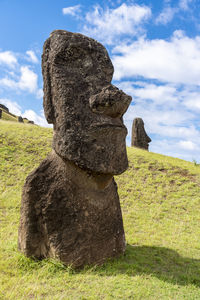 Stone structure on field against sky