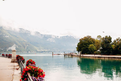 Scenic view of lake by mountain against sky