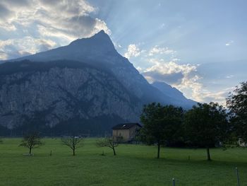 Scenic view of field and mountains against sky