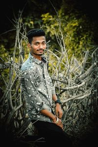 Portrait of young man standing on field