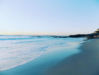 Scenic view of beach against clear sky