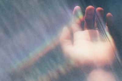 Close-up of woman hand against sky