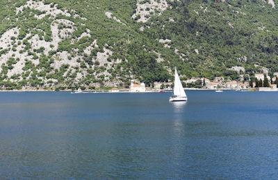 Sailboat sailing on sea against sky