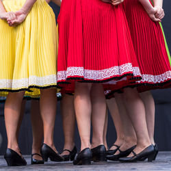 Low section of people in traditional clothing standing outdoors