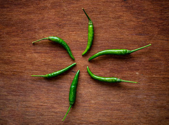 High angle view of green chili peppers on table