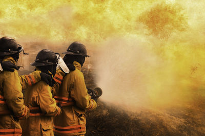 Firefighters spraying water on fire