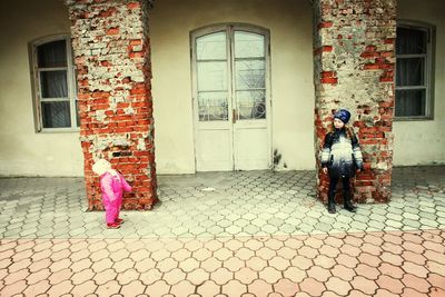 Full length of woman standing by railing