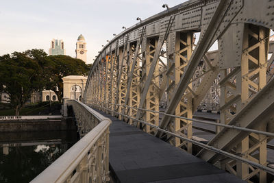 Low angle view of bridge and buildings against sky