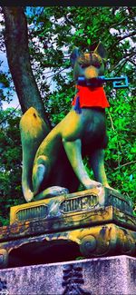 Low angle view of statue against trees