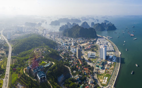 High angle view of buildings by sea against sky