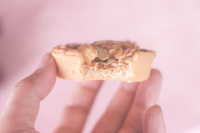 Close-up of hand holding cake