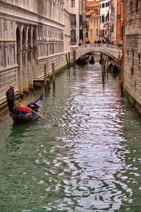 Boats in canal along buildings