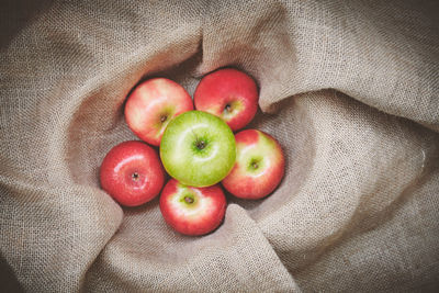 High angle view of apples and fruits on bed