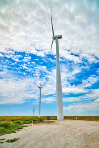 Windmill on field against sky