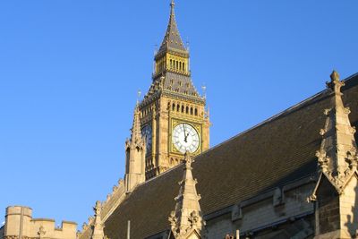 Low angle view of big ben against blue sky