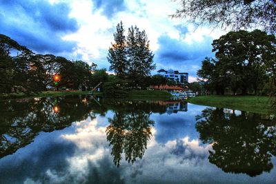 Scenic view of calm lake against cloudy sky