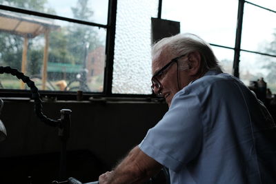 Man sitting on glass window