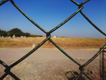 Close-up of chainlink fence against clear sky