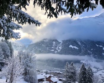 Scenic view of snow covered mountains against sky